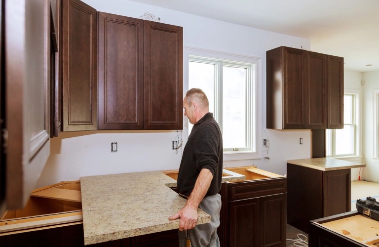 Contractor installing a new laminate kitchen counter top Kitchen more functional with a sink